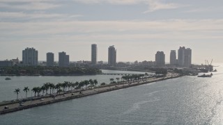 AX0024_068 - 5K aerial stock footage of tracking traffic on MacArthur Causeway, reveal South Beach, Miami Beach, Florida