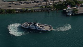 AX0024_070 - 5K aerial stock footage of flying by a ferry turning on Government Cut, Miami Beach, Florida