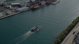 AX0024_071 - 5K aerial stock footage of tracking a ferry sailing on Government Cut, Miami Beach, Florida