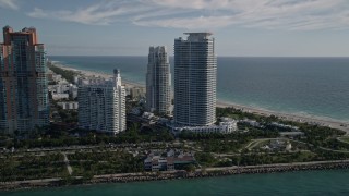 AX0024_075 - 5K aerial stock footage of flying by Portofino Tower and skyscrapers, South Beach, Miami Beach, Florida