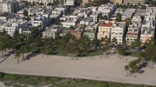 AX0024_095 - 5K aerial stock footage of flying by palm trees at Lummus Park, South Beach, Miami Beach, Florida