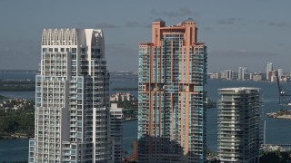 AX0024_097 - 5K aerial stock footage of flying by Portofino Tower and skyscrapers, South Beach, Miami Beach, Florida