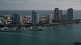AX0024_102 - 5K aerial stock footage of approaching Miami Beach Marina, skyscrapers in South Beach, Miami Beach, Florida