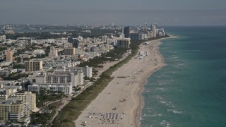 AX0024_113E - 5K aerial stock footage of flying by South Beach coastline, reveal skyscrapers in Miami Beach, Florida
