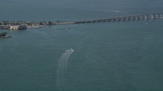AX0024_118 - 5K aerial stock footage of approaching speedboat in Biscayne Bay, Miami, Florida