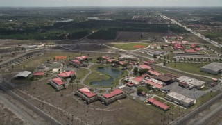 AX0025_003 - 5K aerial stock footage of approaching Federal Correctional Institution, Miami, Florida