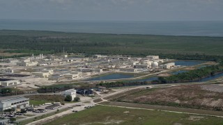 AX0025_010 - 5K aerial stock footage of flying by the  South District Wastewater Treatment Plant, Homestead, Florida