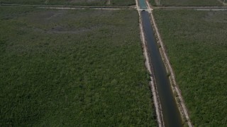AX0025_016 - 5K aerial stock footage flyby canal, reveal length of canal and Mangrove Preserve, Homestead, Florida