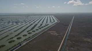AX0025_026 - 5K aerial stock footage of flying beside Turkey Point Power Plant cooling canal system, Homestead, Florida