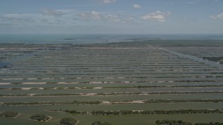 AX0025_027 - 5K aerial stock footage of flying by Turkey Point Power Plant cooling canal system, Homestead, Florida
