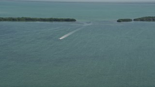 AX0025_045 - 5K aerial stock footage of flying by a speedboat on Manatee Bay, Boynton Beach, Florida