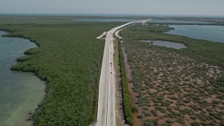 AX0025_051 - 5K stock footage aerial video follow traffic on Overseas Highway, Key Largo, Florida