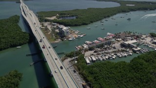 AX0025_052E - 5K stock footage aerial video of Overseas Highway, the Anchorage Resort and Yacht Club,  and Gilbert's Resort, Key Largo, Florida