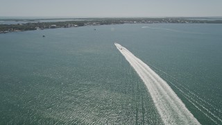 AX0025_059 - 5K aerial stock footage of following two boats racing to shore across Blackwater Sound, Key Largo, Florida