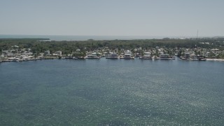 AX0025_064 - 5K aerial stock footage of flying by homes on the shore of Blackwater Sound, Key Largo, Florida