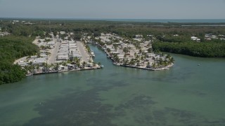 AX0025_066 - 5K aerial stock footage of flying by Calusa Camp Resort by Buttonwood Sound, Key Largo, Florida