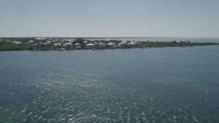 AX0025_070 - 5K aerial stock footage of flying by homes on Buttonwood Sound, Key Largo, Florida