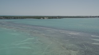 AX0025_083E - 5K aerial stock footage of approaching a home on the shore, Tavernier, Florida