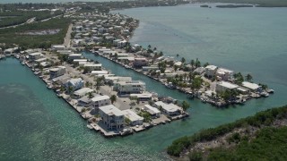AX0025_086 - 5K aerial stock footage video of flying over homes on the shore, Tavernier, Florida
