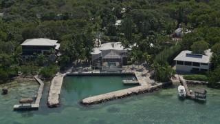 AX0025_102 - 5K aerial stock footage of homes with docks on the shore, Tavernier, Florida