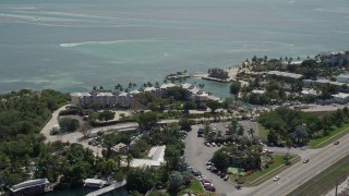 AX0025_108 - 5K aerial stock footage of flying by the coastal Holiday Isle Resort and Marina, Islamorada, Florida