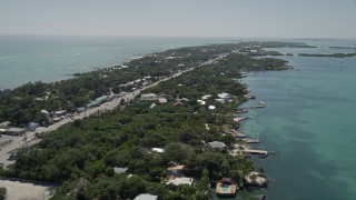 AX0025_110E - 5K aerial stock footage of following Overseas Highway, revealing Upper Matecumbe Key, Islamorada, Florida