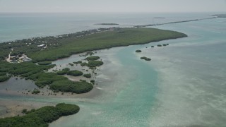 AX0025_116 - 5K aerial stock footage of following a dredge to approach mangroves near coast, Islamorada, Florida