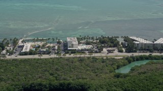 AX0025_118 - 5K aerial stock footage of flying by Breezy Palms Resort, Hampton Inn and Suites, Islamorada, Florida