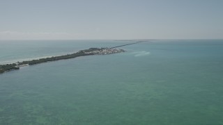 AX0025_141 - 5K aerial stock footage tilt from open water revealing homes on Long Key, Layton, Florida