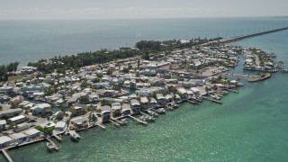 AX0025_142 - 5K stock footage aerial video of approaching and flying by coastal neighborhood, Long Key, Layton, Florida