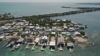 AX0025_147 - 5K stock footage aerial video of flying by small neighborhood on Conch Key, Marathon, Florida