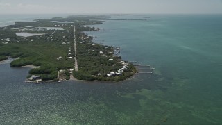AX0025_154 - 5K aerial stock footage of approaching homes on the shore of Grassy Key, Marathon, Florida