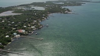 AX0025_155 - 5K aerial stock footage fly by homes on shore of Grassy Key, Marathon, Florida