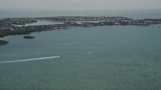 AX0025_162 - 5K aerial stock footage of tracking speed boat off the shore, Fat Deer Key, Marathon, Florida