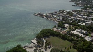 AX0026_003 - 5K stock footage aerial video of approaching coastal homes by the water, Marathon, Florida
