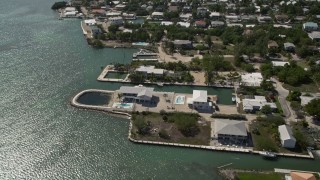 AX0026_005 - 5K aerial stock footage of flying over oceanfront homes in Marathon, Florida