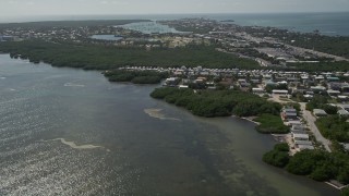 AX0026_006 - 5K aerial stock footage of following coast, approaching Sombrero Country Club, Marathon, Florida