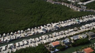 AX0026_007 - 5K stock footage aerial video of homes on coastal canal, Marathon, Florida