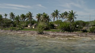AX0026_042 - 5K aerial stock footage of huts for Girl Scout Camp Wesumkee on Scout Key, Florida