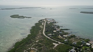 AX0026_049E - 5K aerial stock footage of approaching homes and small marina, Big Pine Key, Florida