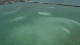 AX0026_051 - 5K aerial stock footage of flying over murky water off the shore of Little Torch Key, Florida