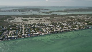 AX0026_052 - 5K aerial stock footage of flying over homes along the shore, wetlands, Little Torch Key, Florida