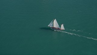 AX0026_074 - 5K aerial stock footage of a sailboat off the shore of Key West, Florida