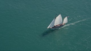 AX0026_075 - 5K aerial stock footage of a sailboat on the ocean near Key West, Florida