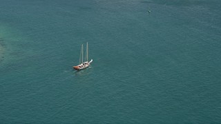 AX0026_094 - 5K aerial stock footage of tracking a sailboat on the open water by Key West, Florida