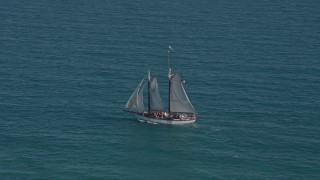 AX0026_104E - 5K aerial stock footage of tracking a sailboat near Key West, Florida