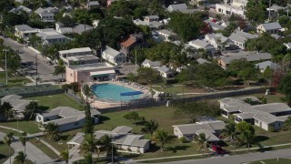 AX0026_113 - 5K aerial stock footage of flying by a large pool behind a house on Key West, Florida