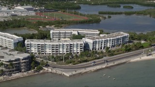 AX0026_117 - 5K aerial stock footage of apartment buildings by the ocean in Key West, Florida