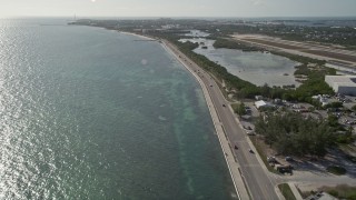 AX0027_003 - 5K aerial stock footage of following South Roosevelt Boulevard, Key West, Florida