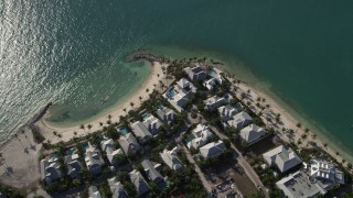 AX0027_017 - 5K aerial stock footage of flying by homes along the beach, Sunset Key, Key West, Florida